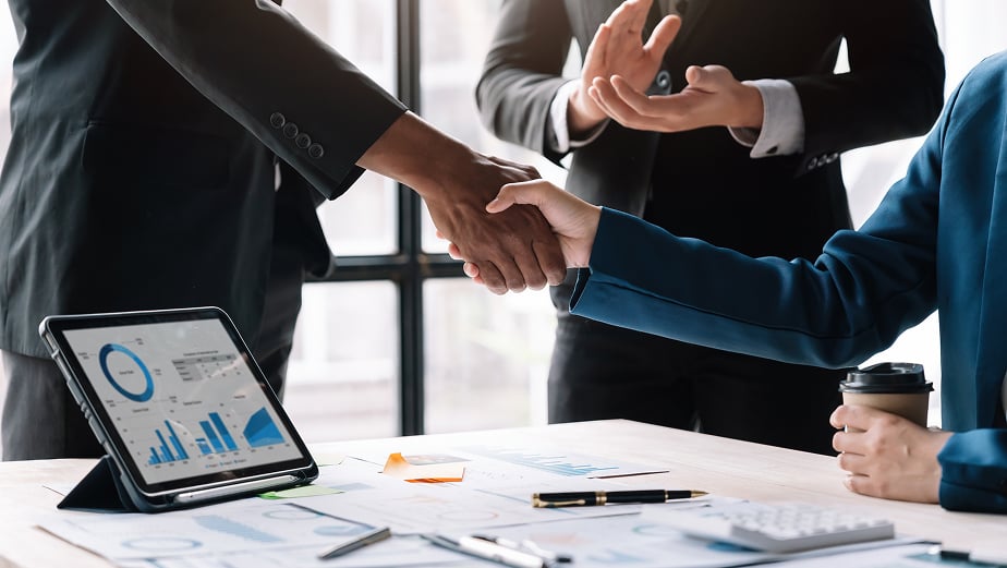 A close-up of a firm handshake between two business professionals